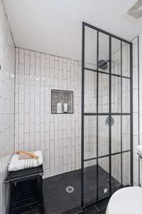 Completely renovated primary bath with niche for bath products