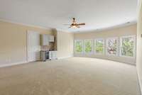 A wet bar and wine fridge are in the corner. Perfect spot for watching the games.