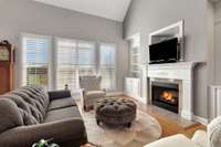 The living room has vaulted ceilings, builtins and a fireplace.