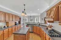 The sunny kitchen is open to the family room and has an island for a great workspace.