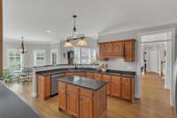 The kitchen has lots of cabinets, counterspace and a built in desk area.