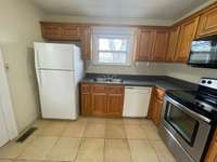 Kitchen includes appliances. Outside exit to large deck located in kitchen.