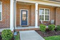 The fully-covered front porch is one of two great outdoor spaces at this townhome; the other being the private back patio.