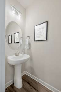 Half bathroom on the main floor, located near the front of the townhome.