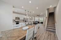 A standout feature of this floor plan is the discreet rear stairway, which avoids the abrupt stairs-at-the-door feel of some other townhomes. This creates a more elegant, welcoming entry in this home.