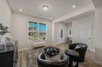 This floor plan has a flex room, a distinct—yet open—space that could serve as an office, formal dining area, kids’ playroom, or a second, more formal living space. The door on the right leads to the half bathroom.