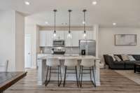 Another view of the kitchen from the dining area. The door on the far left wall is the pantry.