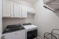 The laundry room cabinets & walls have been freshly painted offering a functional space for all your household needs. With its neat layout and ample storage, it ensures laundry day is as efficient and hassle-free as possible.