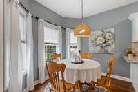 Stylish fixture in breakfast nook adds a refined touch, making it an ideal setting for everyday living and elegant entertaining.