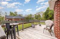 The back deck is an ideal spot for relaxing and enjoying the outdoors, offering a serene space to unwind, entertain, or simply take in the fresh air.