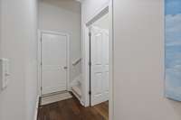 Hallway leading to laundry room, garage & upstairs.