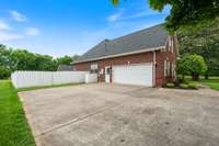 A pristine concrete driveway leads up to the garage, offering both durability and curb appeal. This wide, smooth surface ensures easy access and ample parking, adding to the home's functional and attractive exterior.