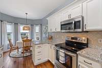 The kitchen offers abundant counter space for meal prep and entertaining, along with sleek high-quality appliances that blend style and functionality.