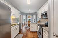 The kitchen offers abundant counter space for meal prep and entertaining, along with sleek high-quality appliances that blend style and functionality.