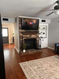 Open living space ... wood burning fireplace ... Big screen TV stays, if buyers chooses.