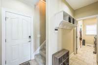 Door leading to garage and steps lead to bonus room