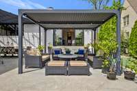 Pergola with room for large gatherings and a fire-pit that is plumbed for natural gas