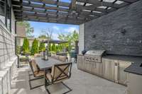 Outdoor Kitchen with granite countertops with leather finish. A louvered roof to allow natural light and shade. An oversized fan designed to push any bugs or smoke out of the cooking area.