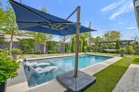 Swimming pool with tanning ledge, 2 lounge chairs, pool lighting and fountains