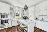 This kitchen has abundant storage with floor to ceiling cabinets and butler's pantry around the corner. The island is nice for a quick breakfast while staying warm by another of the renovated fireplaces.