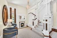 Enter from the columned wrap around porch into the front foyer with gorgeous original stained glass window, working gas fireplace and cozy bench seat. The period staircase has custom wool runner and vintage crystal light fixture.