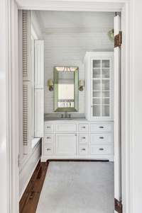 Upstairs master bath with custom cabinet and painted brick walls.