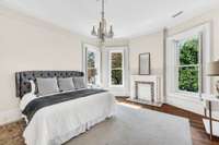 This beautiful sun-filled master bedroom is located upstairs. It has beautiful shutters and the entire home has neutral paint and decor.