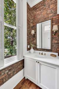 The sellers worked with a local designer to select quality period finishes and exposed the original brick wall.