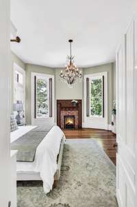 Downstairs bedroom has a renovated full bath attached and a doorway to the covered wrap around porch. This home has the most amazing natural light!