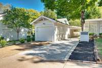 This is the 10th Avenue side of the property with renovated garage with new cement floor and Hardie Board siding. Middle wall is removable to make it a two car tandem if buyer desires. Covered parking and nice yard area to the right.