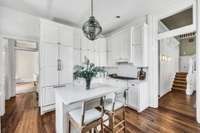 The kitchen has a second prep sink and gas cooktop. The built-in refrigerator remains. The home has a whole house water filter and additional drinking filter at the prep sink.