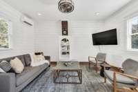 The kitchen had a wood stove where the bookshelf is located. The sellers left the original brick chimney. This great space could be a nice remote office, music studio, or teen rec room.