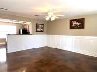 Living room is open to kitchen/dining area for extended natural lighting on the main level.