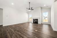 living room with high ceilings and large windows. Gas Fire place