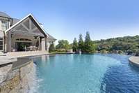 This outdoor oasis features a heated Rondo inifinity pool and hot tub with panoramic views of the TN hills and the private, wooded tree-line