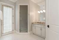 En-suite bathroom also features a convenient door to the pool area