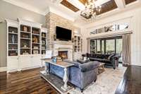 The Great Room is highlighted by a floor-to-ceiling stone gas firplace surrounded by built-ins and an awe-inspiring wood inlay coffered ceiling