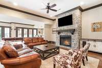Amazing walk-out lower level features a floor-to-ceiling gas fireplace and mounted TV in the Family Room area