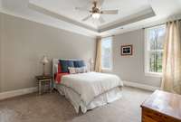 En-suite 3BR with a tray ceiling, walk-in closet and ceiling light fan