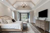 The Owner's suite features an artistic boxed cathedral ceiling with wood inlay