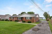 The roof is 11 years old, and the HVAC is 5 years old. A paved drive leads to the rear of the home for easy access.