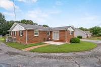 The rear of the home features a sidewalk leading to the patio off the den/office or whatever you decide.