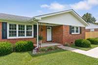The sidewalk leads to the front porch.