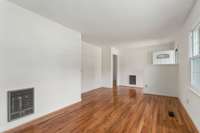 View of the living room from the back of the room to the front door.