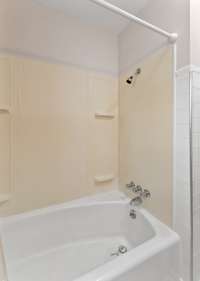 The bathroom has a shower/tub combo.