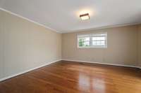 Another view of the den which has laminate flooring.