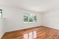 A view of the living showing the large front windows which provide plenty of natural light.