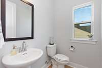 A powder room is located on the main level adjacent to the office for convenience.