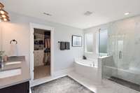 The en-suite bath is equally lavish with quartz countertops, double sinks, a soaking tub and walk-in shower.