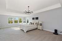 This luxurious primary suite is unique with a sitting room addition and tray ceiling.